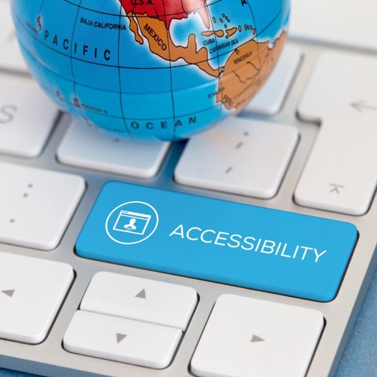 Global Accessibility Awareness day, a small globe sits on a keyboard about the shift key. The shift key has been repurposed, it is blue with a capital A inside a webpage box inside a circle, with ACCESSABILITY written on it in all capital letters.