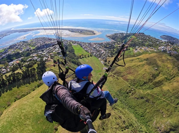 A photo of two people tandem paragliding
