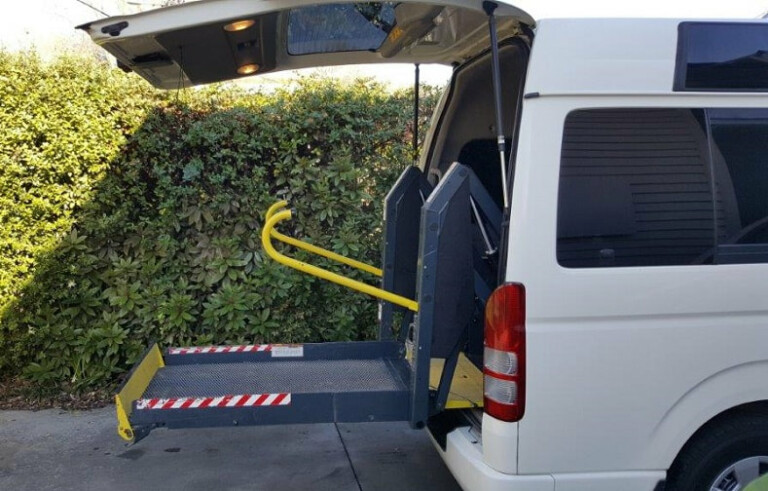 A photo of a wheelchair hoist installed on a van