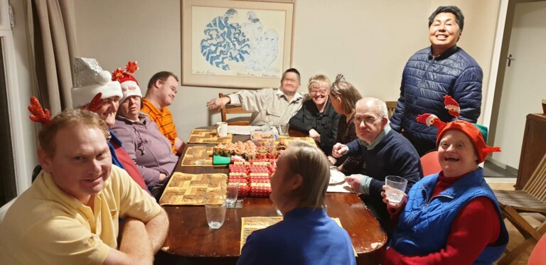 A photo of people gathered round a table for Christmas